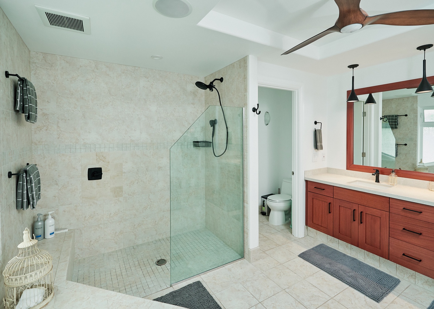 Princeville Vacation Rentals, Hale Kai - Step into your spa-like ensuite bathroom featuring a spacious walk-in shower and elegant double vanity—perfect for unwinding after beach days.