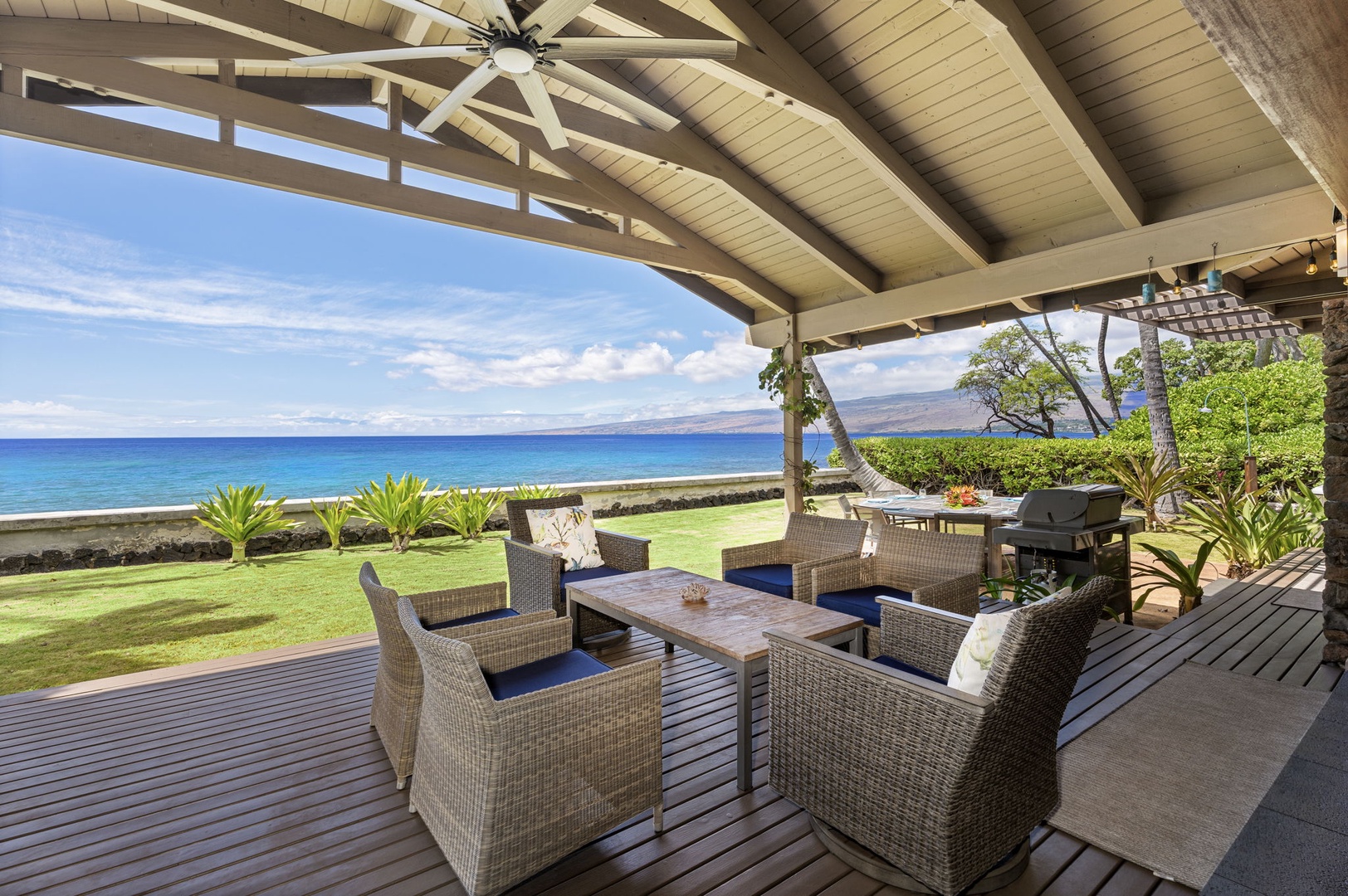 Kamuela Vacation Rentals, Island Time Retreat - Sink into the covered lanai's lounge chairs with the ocean filling the view past the lawn.