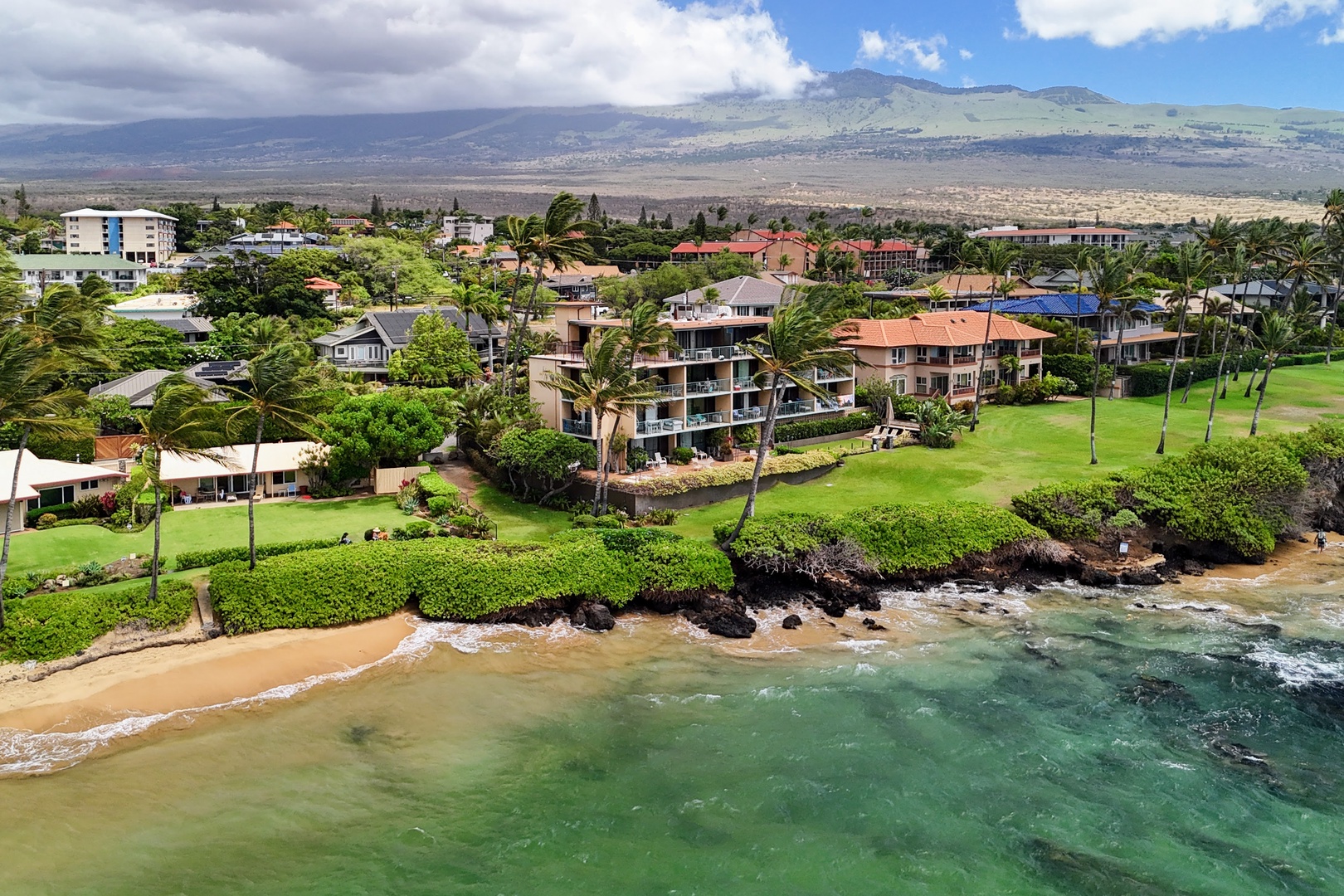 Kihei Vacation Rentals, Punahoa Beach 205 - Clouds settle over the ridgeline while the cove beach stays sunlit right along the water.