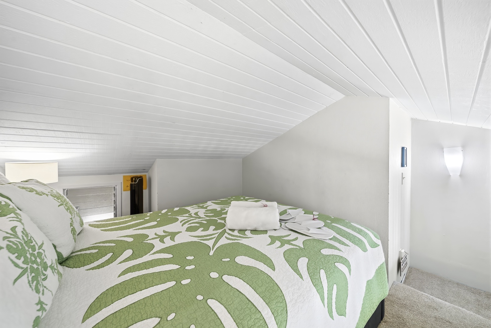 Kahuku Vacation Rentals, Kuilima Estates West #132 - The lofted queen sits beneath a sloped ceiling, a cozy perch above the living space.