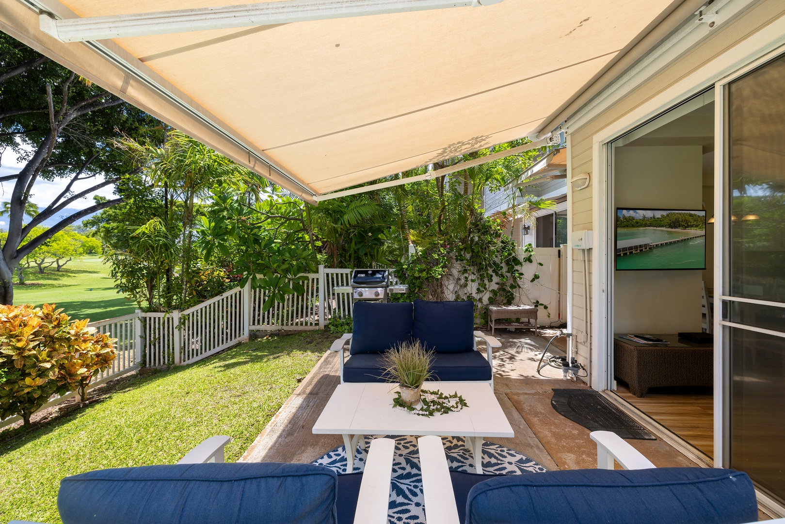 Your private covered terrace opens to lush gardens, where comfortable blue seating invites you to unwind with morning coffee or evening cocktails.