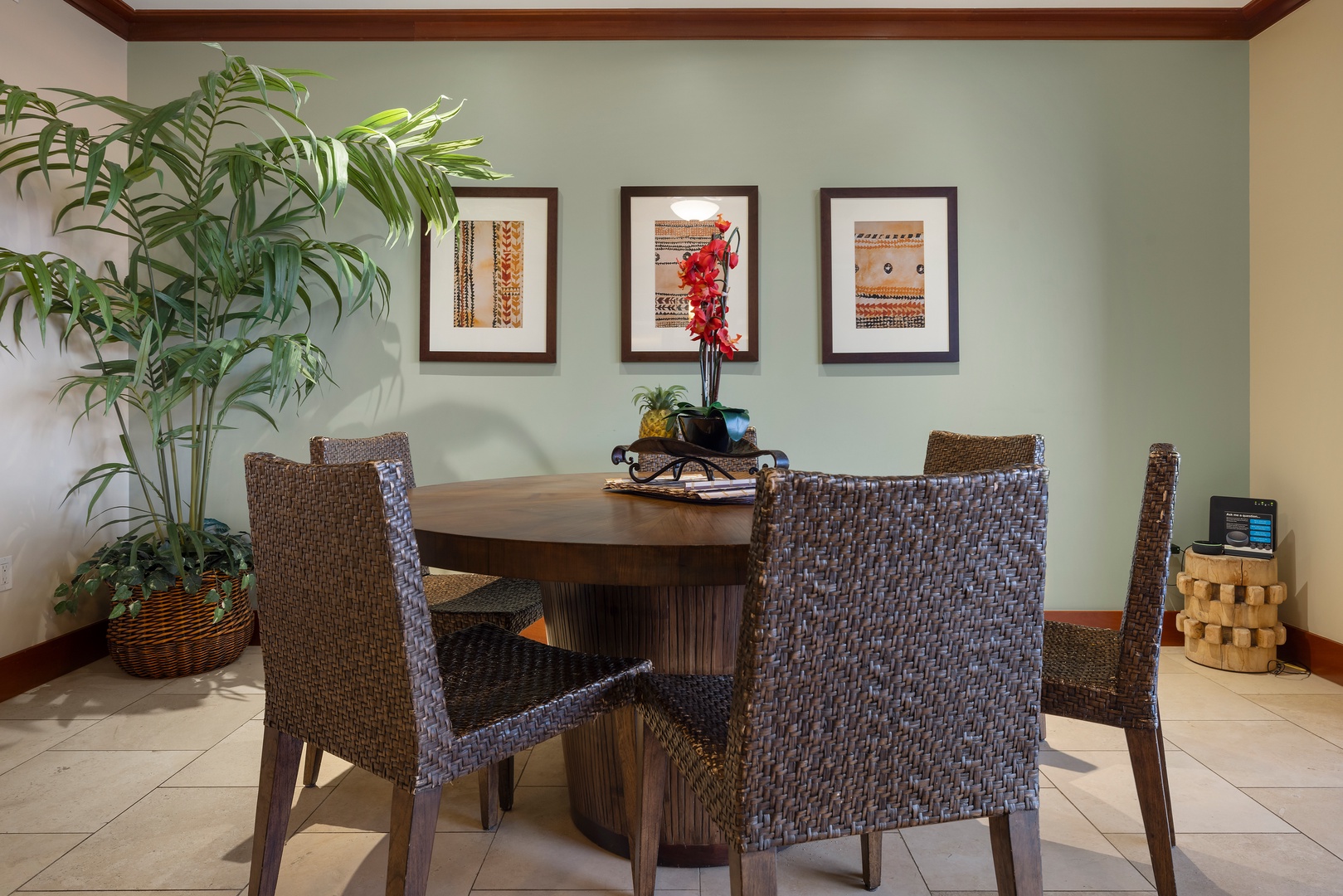 Kapolei Vacation Rentals, Ko Olina Beach Villas O1006 - Dining area with vibrant artwork, and a large plant adding a touch of greenery.