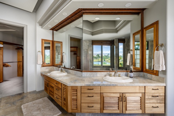 Kamuela Vacation Rentals, Canoe House & Beach Walker at Champion Ridge - Elegant bathroom with dual sinks, a large mirror, and a window view.