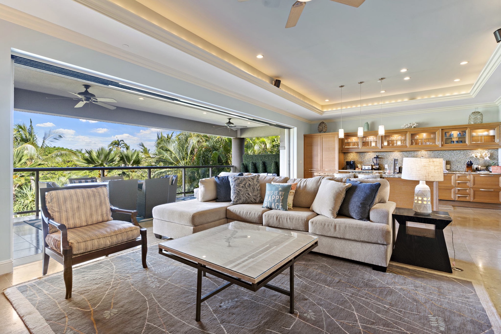 Wailea Vacation Rentals, Wailea Luxury Residence Hoolei 93-3 - This open-concept living area offers seamless indoor-outdoor living with a spacious sectional and views of the lush surroundings.