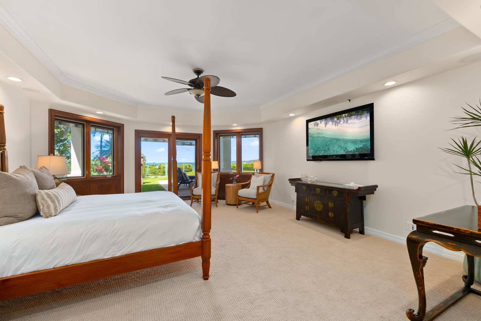 Honolulu Vacation Rentals, Maunalua Estate - Unwind in a spacious bedroom where ocean breezes drift through wood-framed doors and windows.