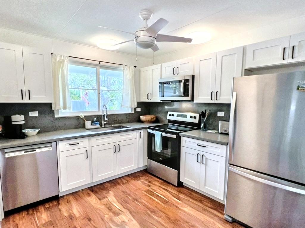 Kailua Vacation Rentals, Lanikai Cottage - Cook with ease in the fully equipped Lanikai Cottage main house kitchen, featuring modern appliances and ample counter space.