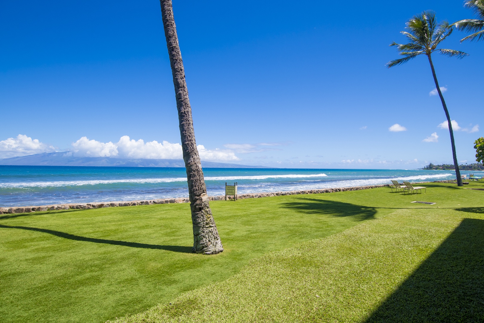 Lahaina Vacation Rentals, Papakea L-106 - Step right outside to a serene oceanfront view, where the blue waves meet the lush green lawn