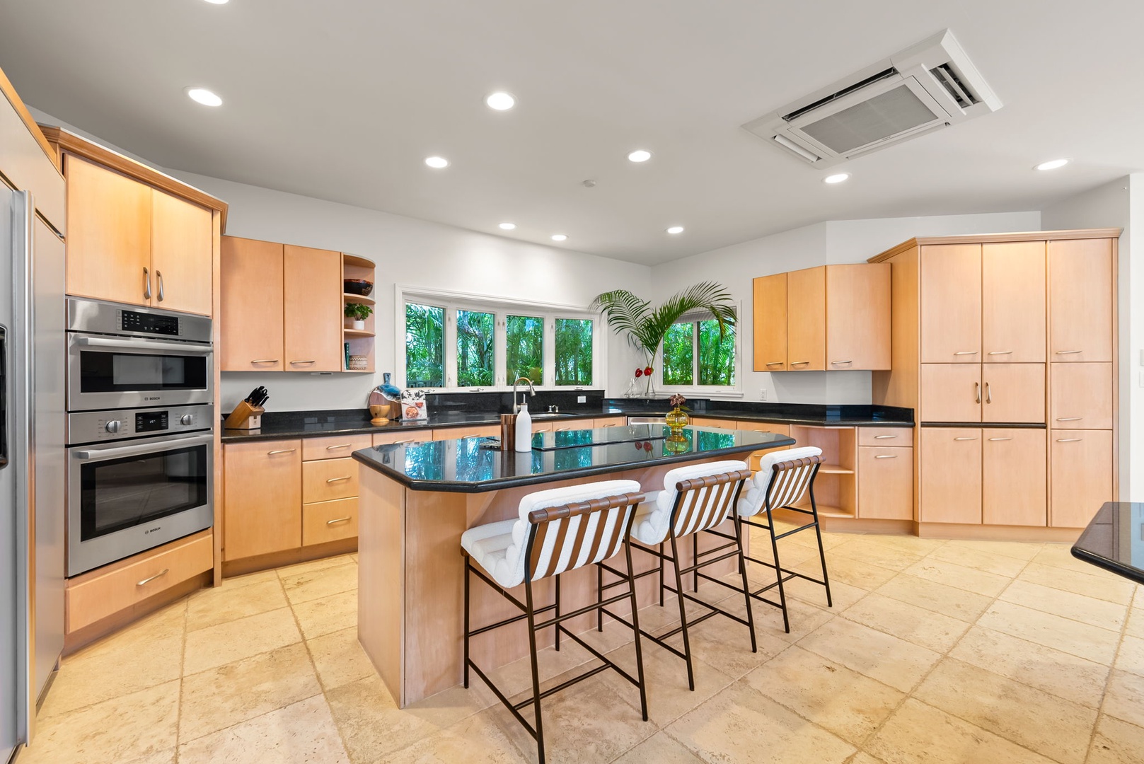 Kailua Vacation Rentals, Kailua Beach House - Modern kitchen with bar seating and easy access to indoor and outdoor dining.