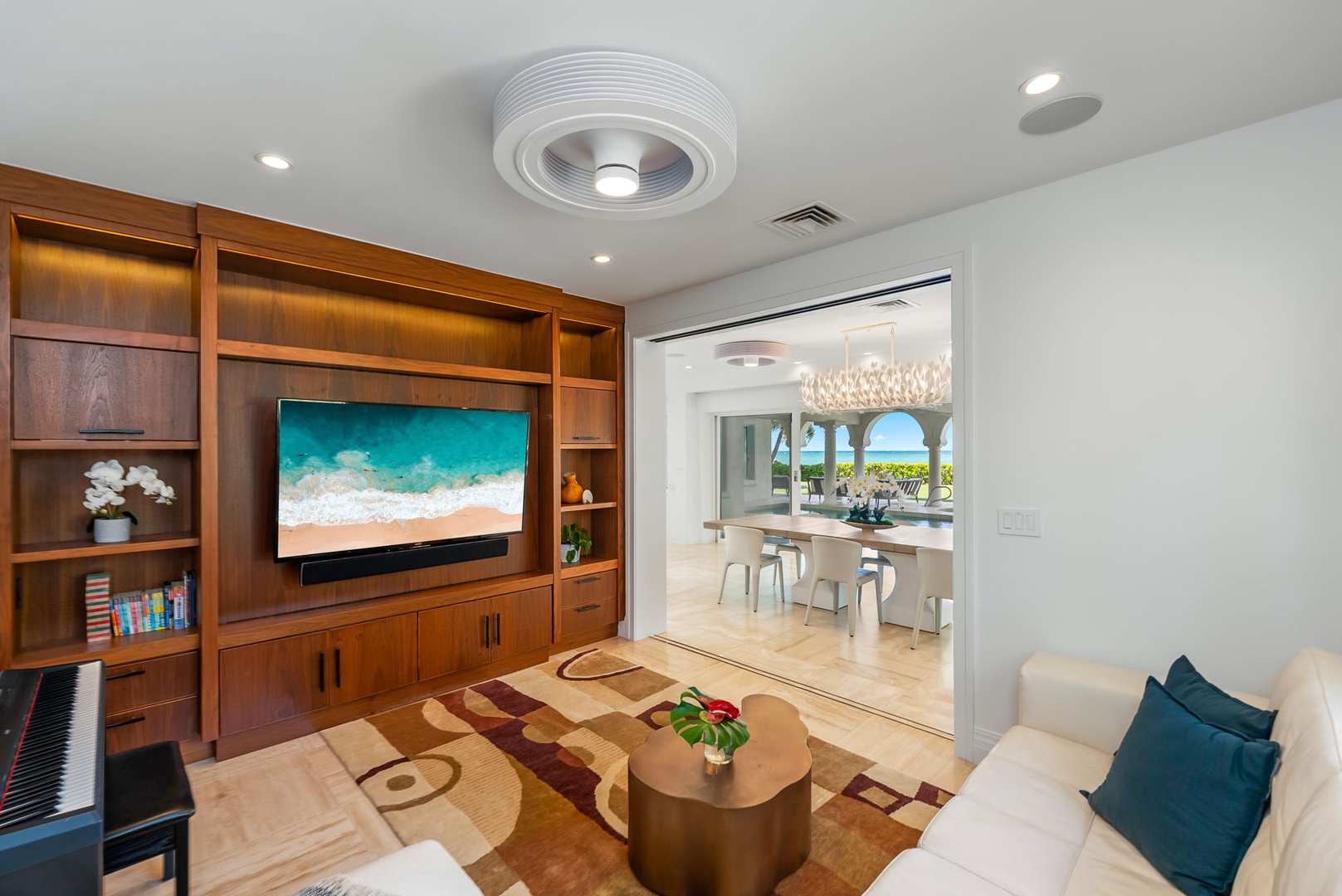 Kailua Vacation Rentals, Lanikai Sunrise Estate - Media lounge with built-in entertainment center, cozy seating, and tropical accents ideal for movie nights.