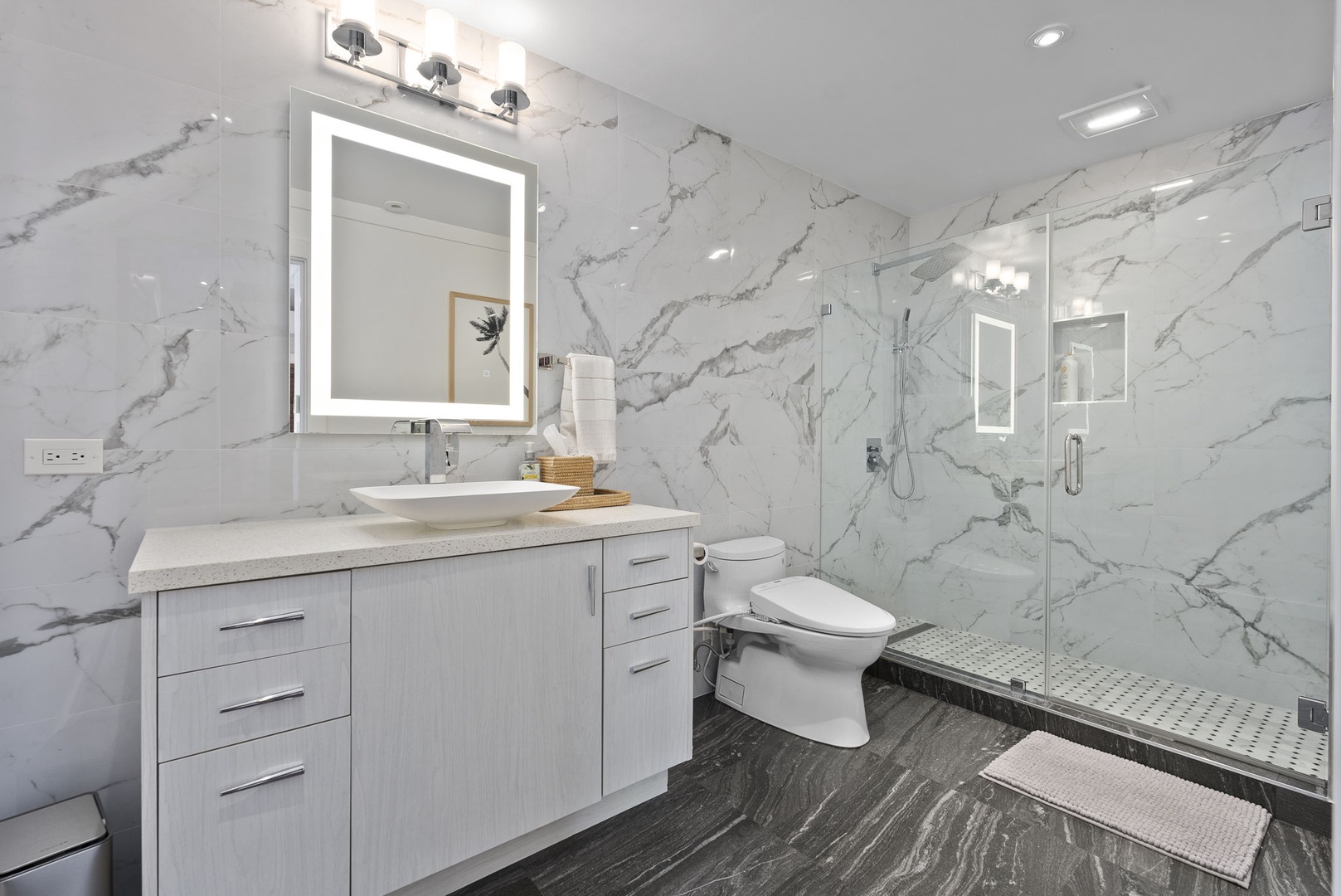 Honolulu Vacation Rentals, The Lagoon House 3BR - Marble bathroom with glass shower, illuminated vanity, and clean modern finishes.