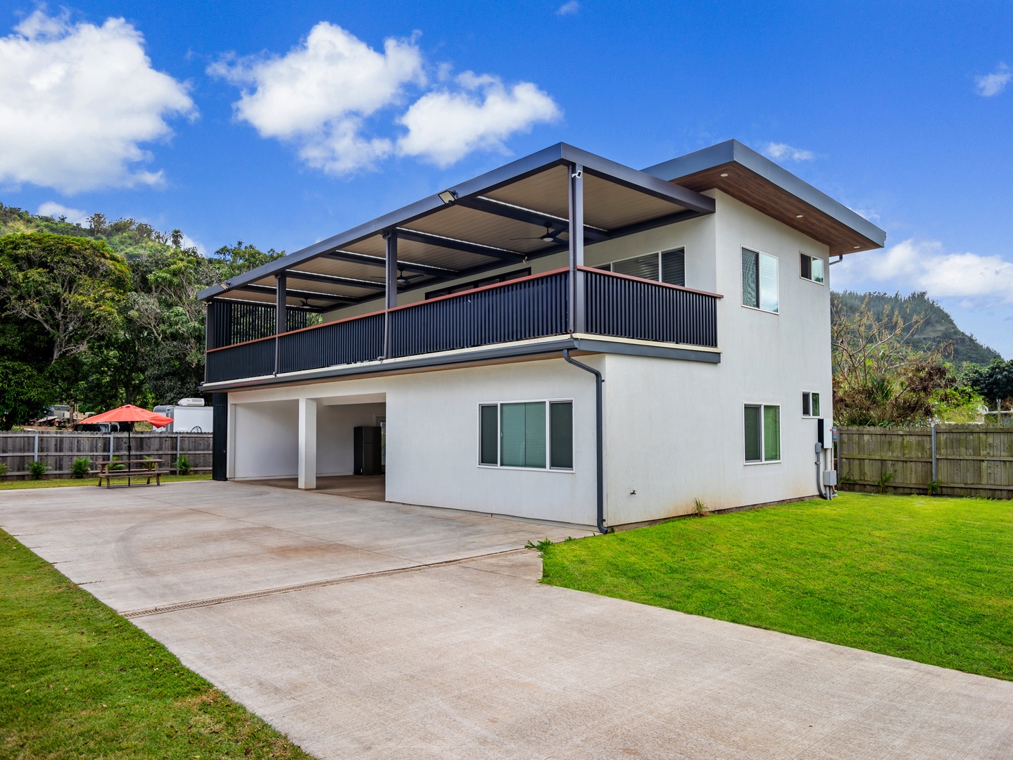 Haleiwa Vacation Rentals, Sunset Beach Island Retreat - This modern two-story home offers a spacious layout with a large covered balcony, perfect for outdoor dining or relaxing with a view.