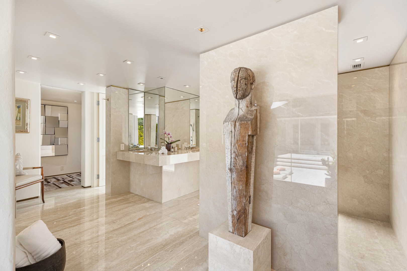 Honolulu Vacation Rentals, Sky Ridge House - The serene statue stands as a testament to elegance, set against the expansive, reflective surface of the mirrors and the sophisticated textures of the bathroom.