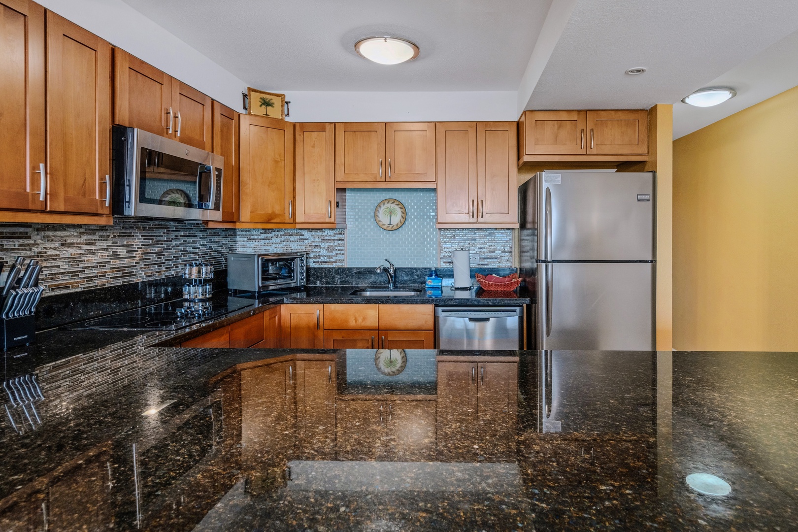Kihei Vacation Rentals, Kamaole Sands 5310 - Notice the palm medallion tucked into the tile backsplash, a small detail worth a second look.