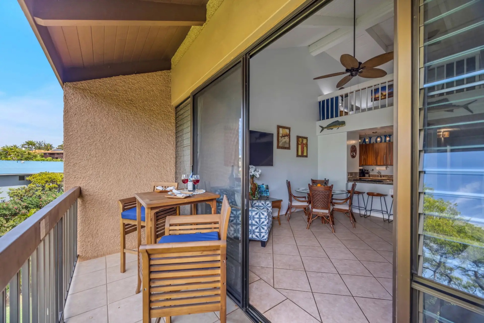 Kihei Vacation Rentals, Maui Vista 2420 - Pour two glasses on the private lanai, treetops and open sky just past the rail.