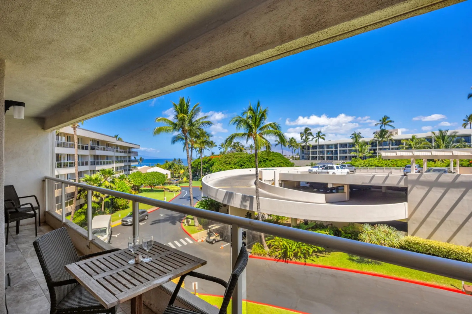 Kihei Vacation Rentals, Maui Banyan H306 - A slice of the Pacific shows between the palms, best caught from the lanai table with morning coffee.