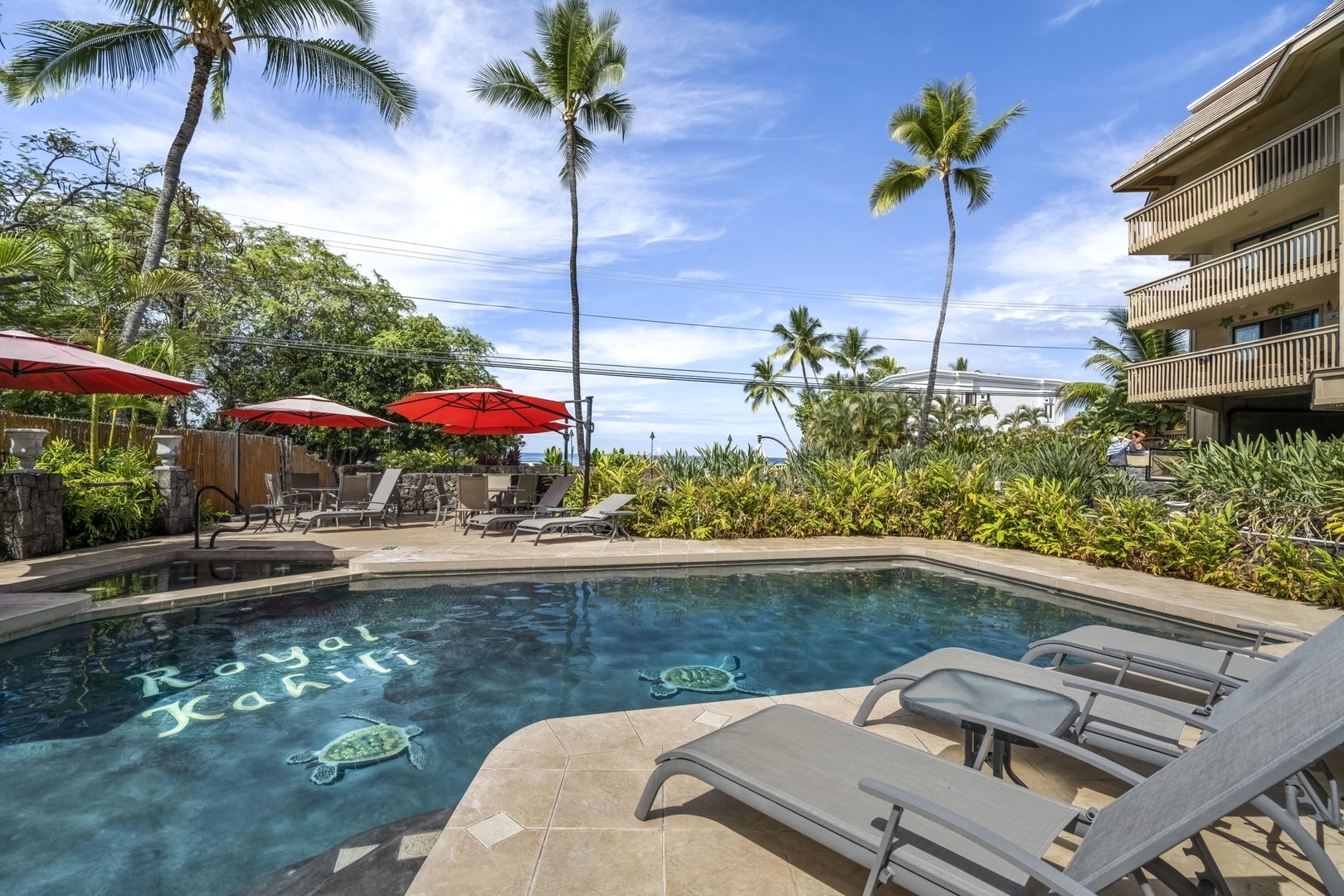 Kailua Kona Vacation Rentals, Royal Kahili 401A - Comfortable poolside setting with ample lounge seating and shaded areas