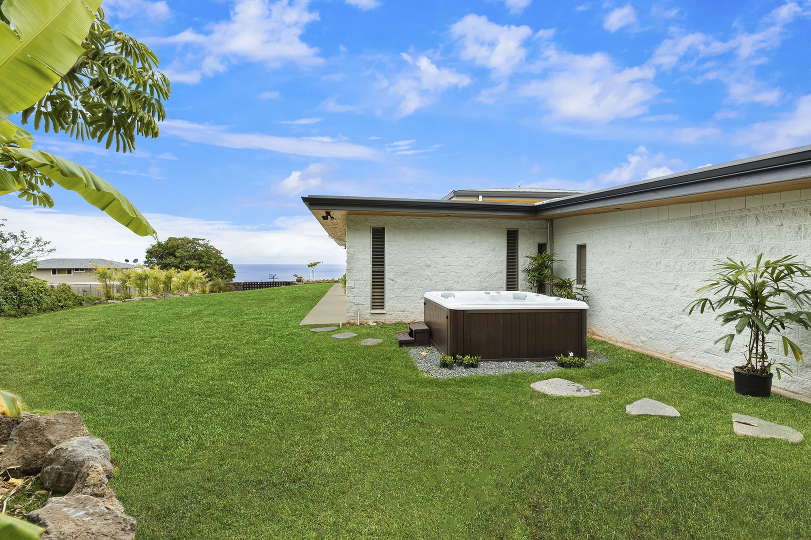 Haleiwa Vacation Rentals, Hale Mahina - Jacuzzi set in a private area of the property with grassy surroundings and mountain air.