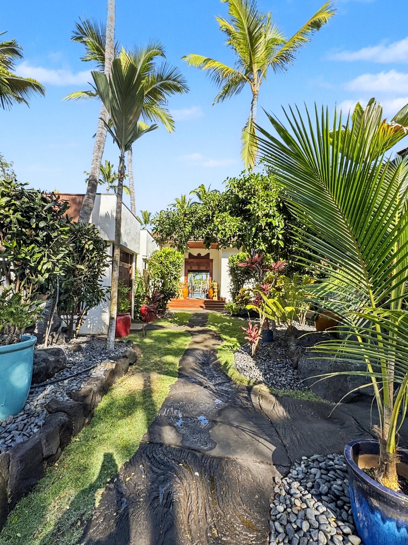 Kailua-Kona Vacation Rentals, Hahalua Bay Villa - Tropical garden pathway with swaying palms and lush landscaping leads to the welcoming entrance of your island retreat.