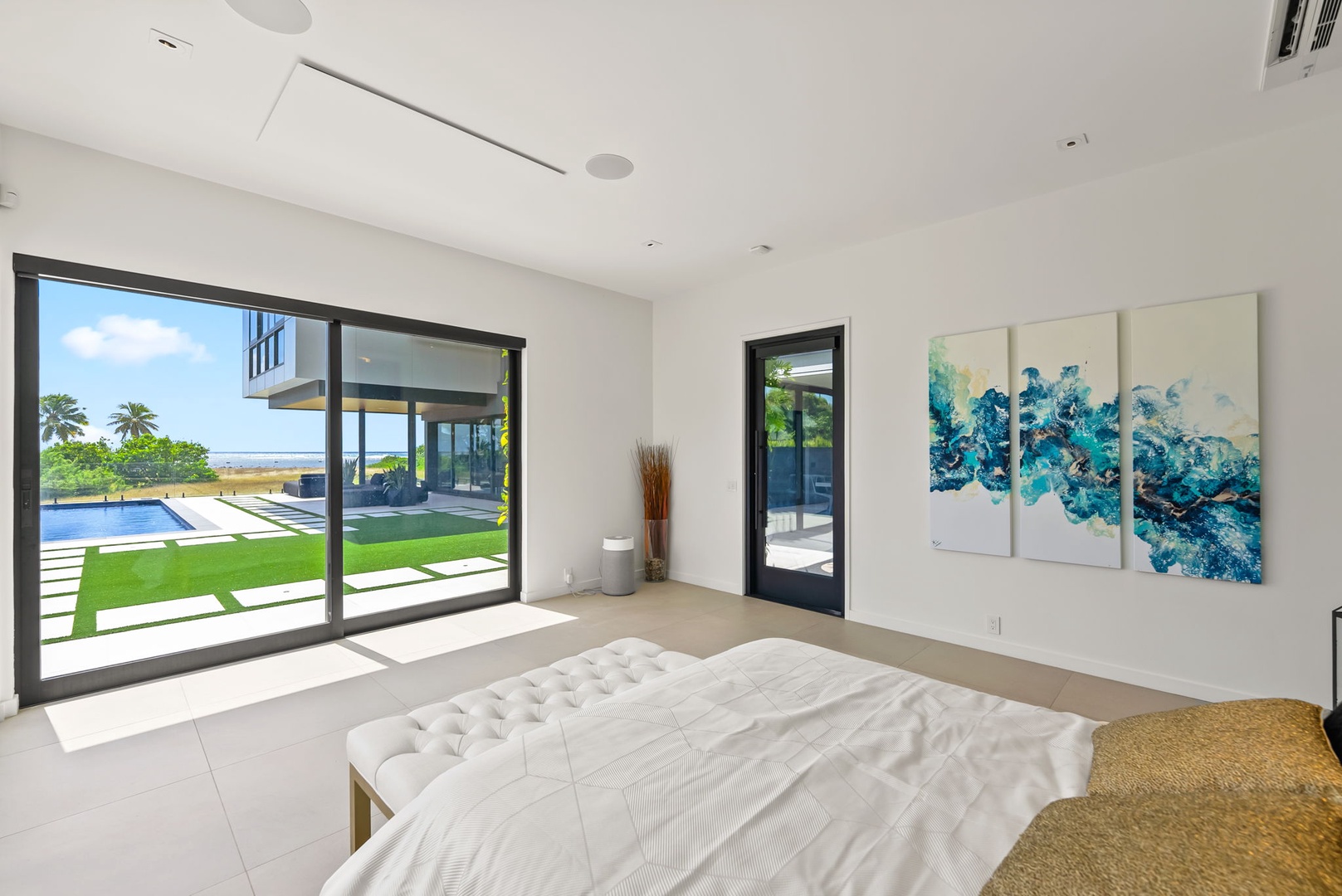Honolulu Vacation Rentals, Ocean Villa 3 Bedroom - Spacious bedroom with natural light, pool views, and modern artwork.