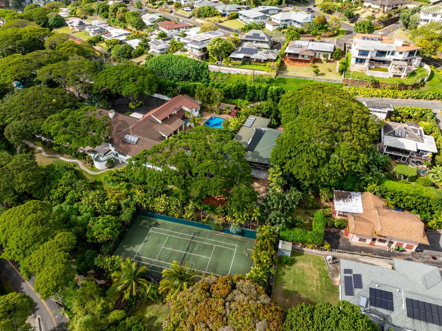 Honolulu Vacation Rentals, Tantalus Glass House - See the full property from above with your private tennis and pickle ball courts and pool, all included in your stay for relaxing and staying active.