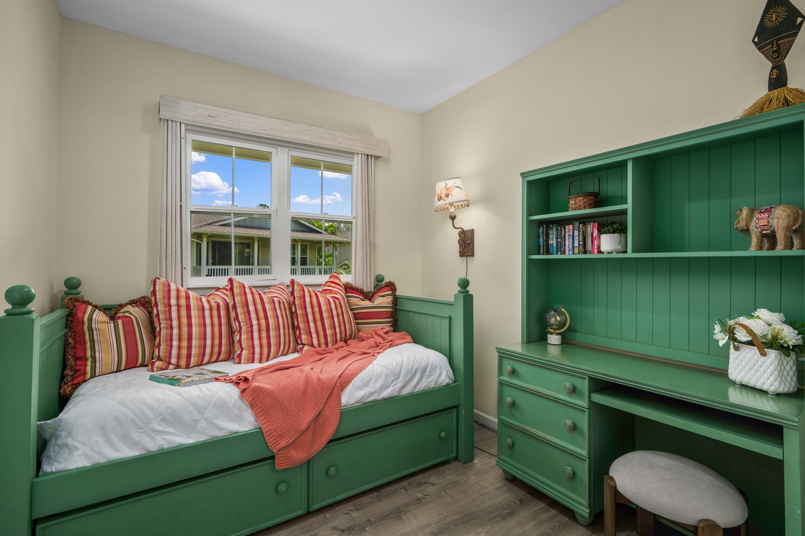 Princeville Vacation Rentals, Kaimana Villa - Features charming green furniture, colorful striped pillows, and a built-in desk perfect for reading or working.