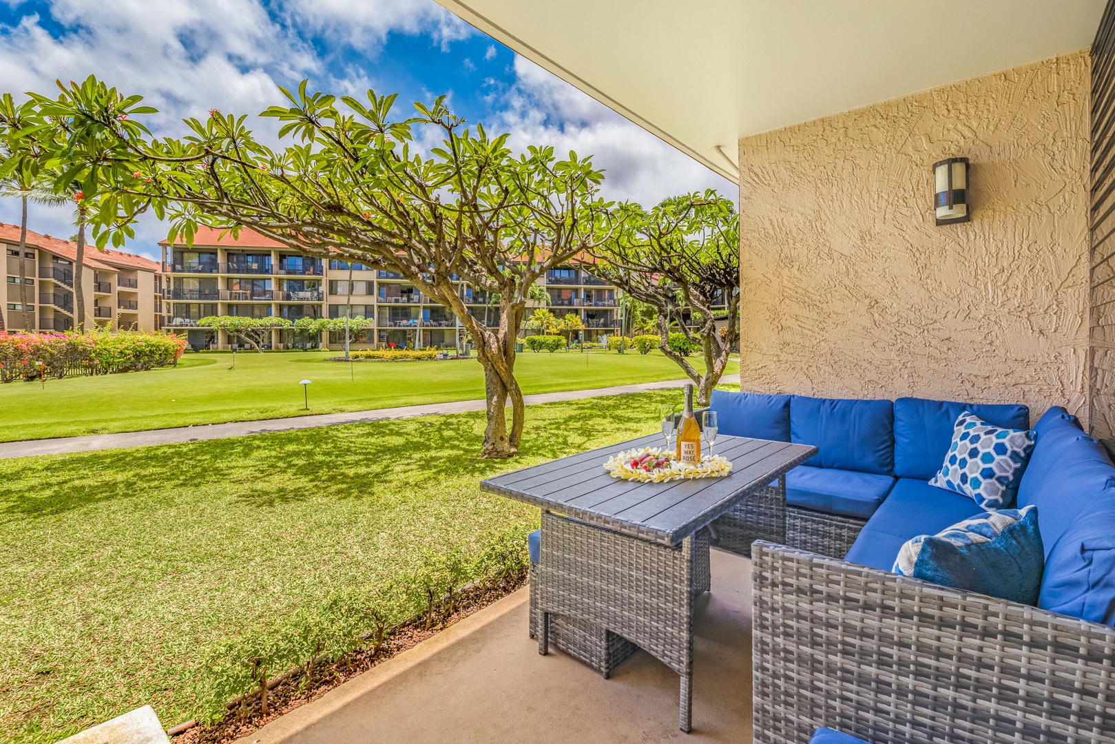 Lahaina Vacation Rentals, Papakea K-105 - The private lanai offers a cozy outdoor seating area, perfect for enjoying meals or drinks while taking in the beautiful garden views and fresh air.