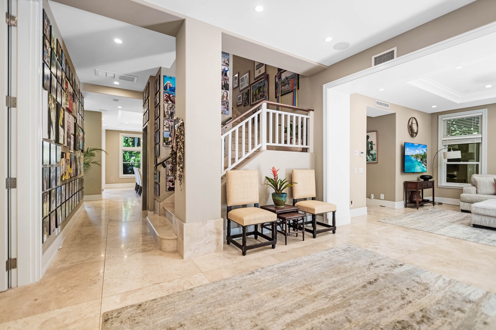 Honolulu Vacation Rentals, Pili Pono - Entryway featuring a custom staircase and tropical artwork.