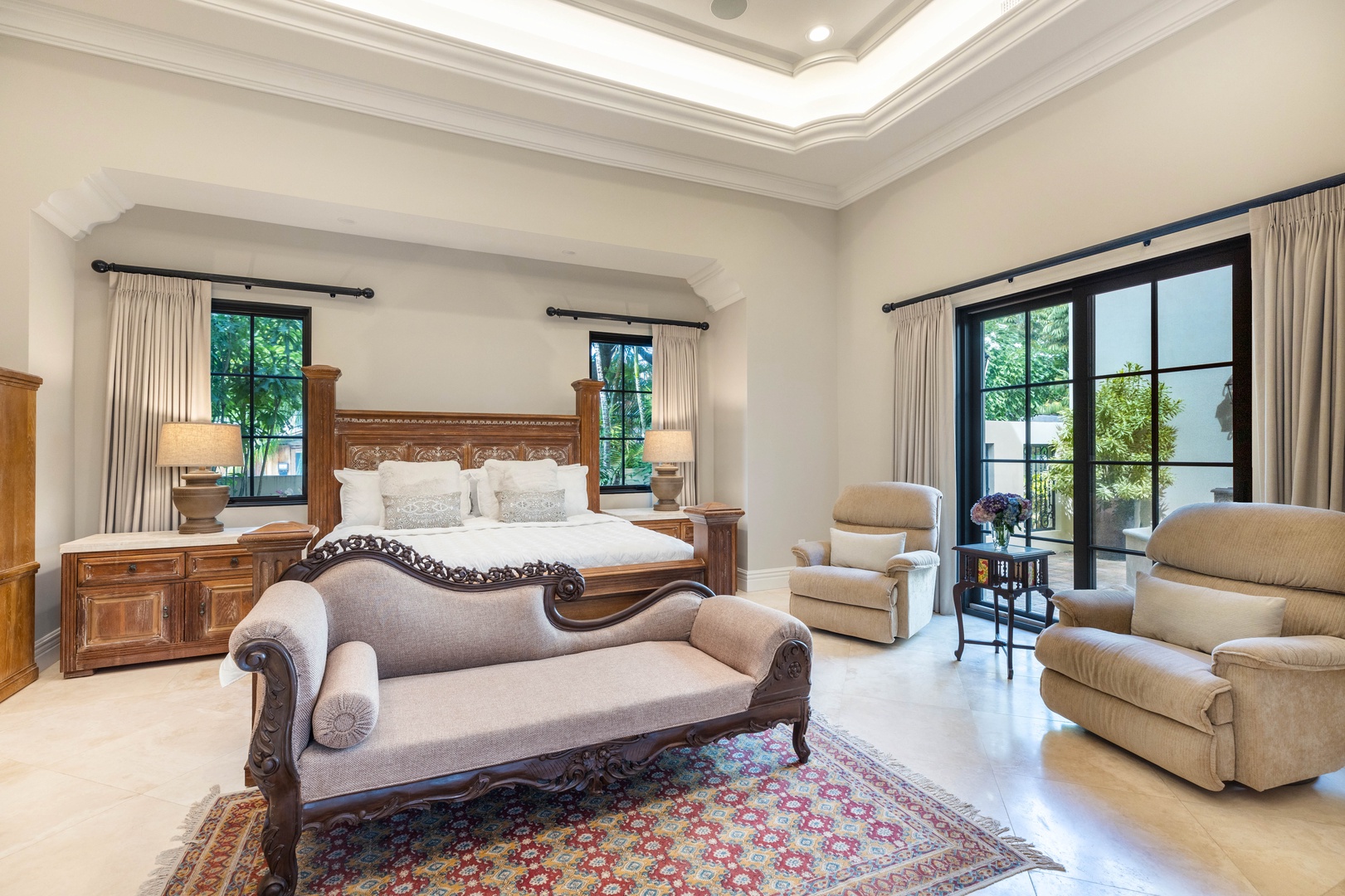 Honolulu Vacation Rentals, The Kahala Mansion Event Venue - Sophisticated primary suite with luxurious furnishings, tray ceilings, and access to a private patio.