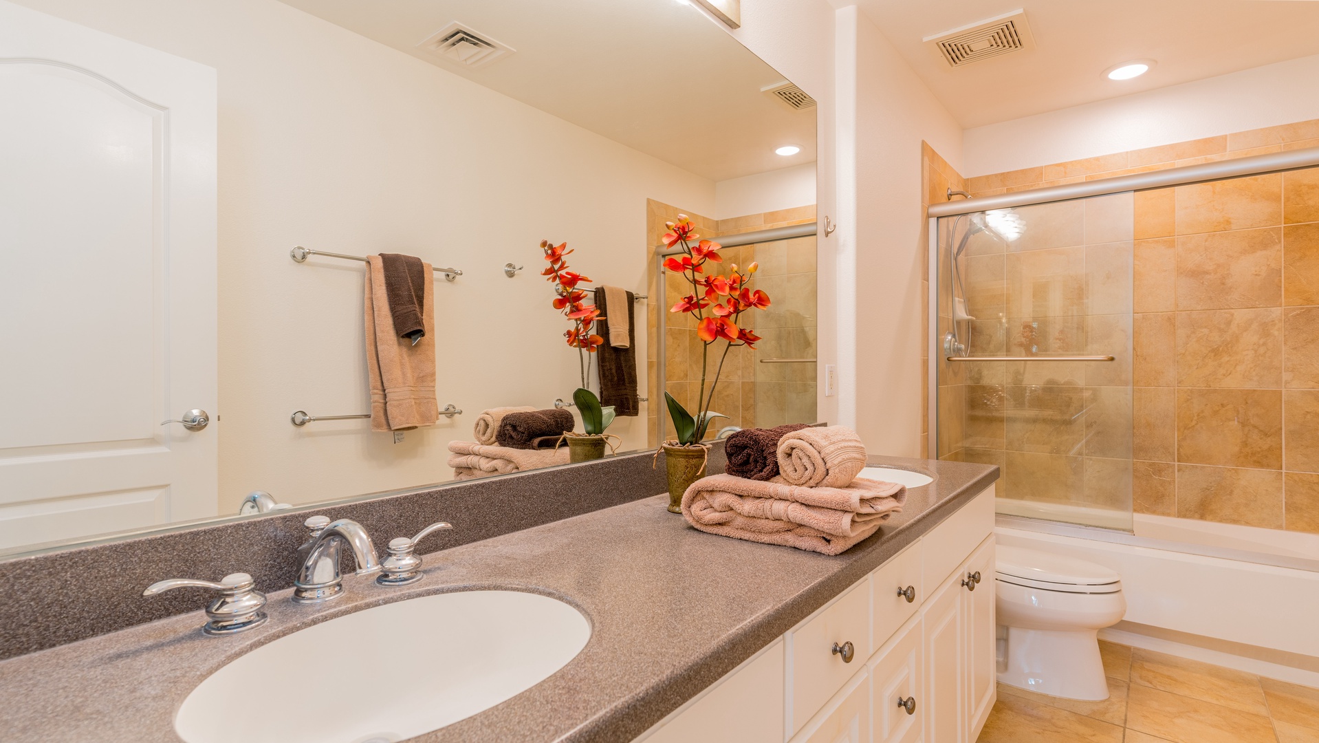 Kapolei Vacation Rentals, Ko Olina Kai 1057B - The primary guest bathroom with a double vanity and shower.
