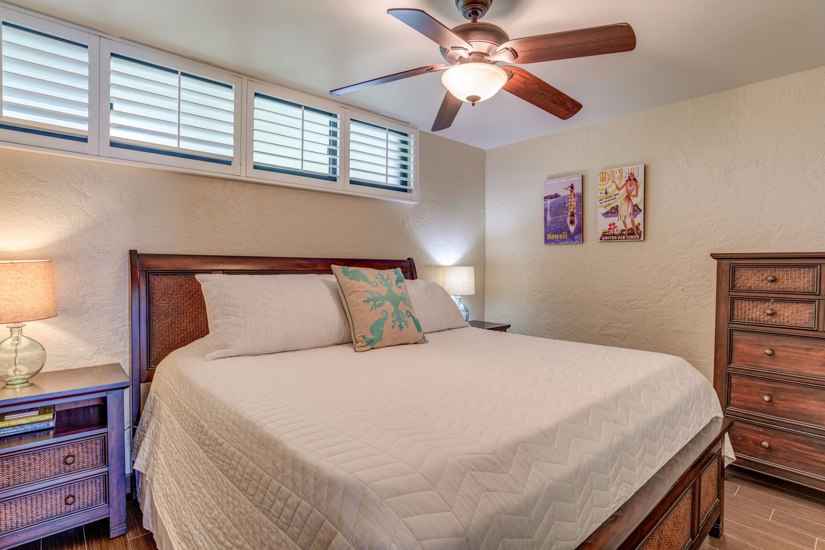 Lahaina Vacation Rentals, Papakea B-105 - The cozy primary bedroom offers a king-size bed with plush bedding, creating a restful retreat after a long day of island adventures.