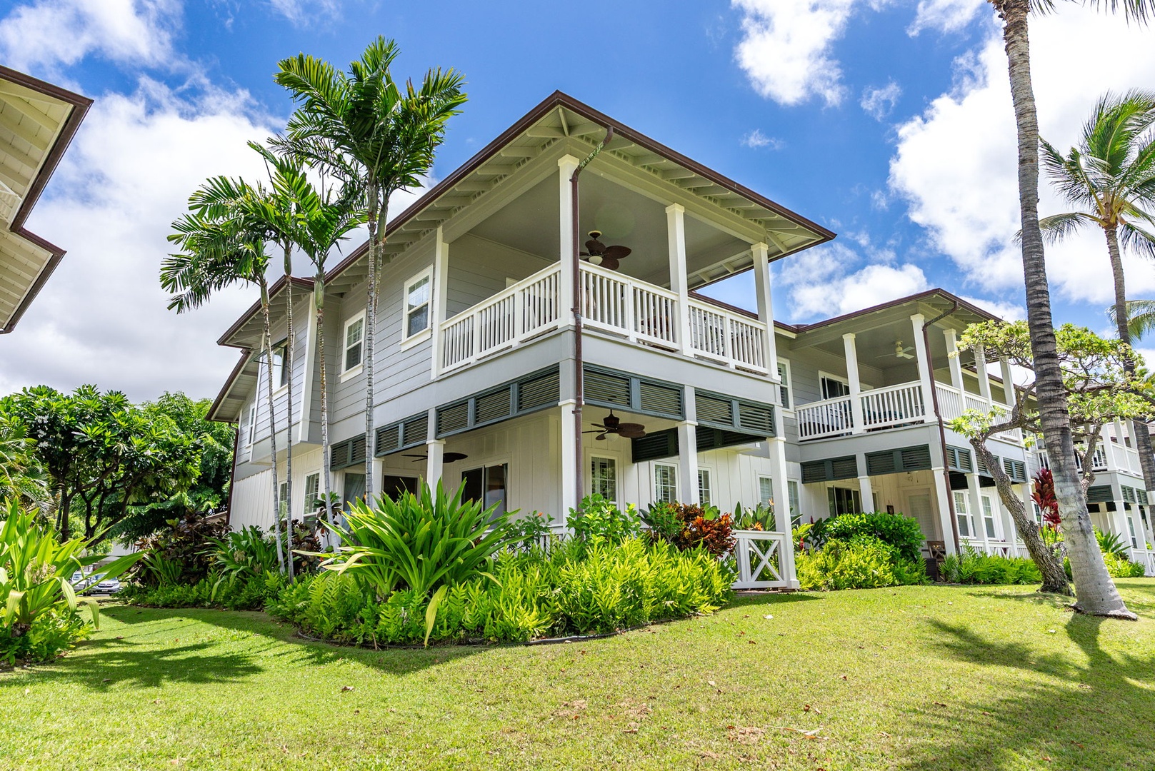 Kapolei Vacation Rentals, Coconut Plantation 1080-4 - Two-story plantation-style townhome fronting a wide, green lawn.