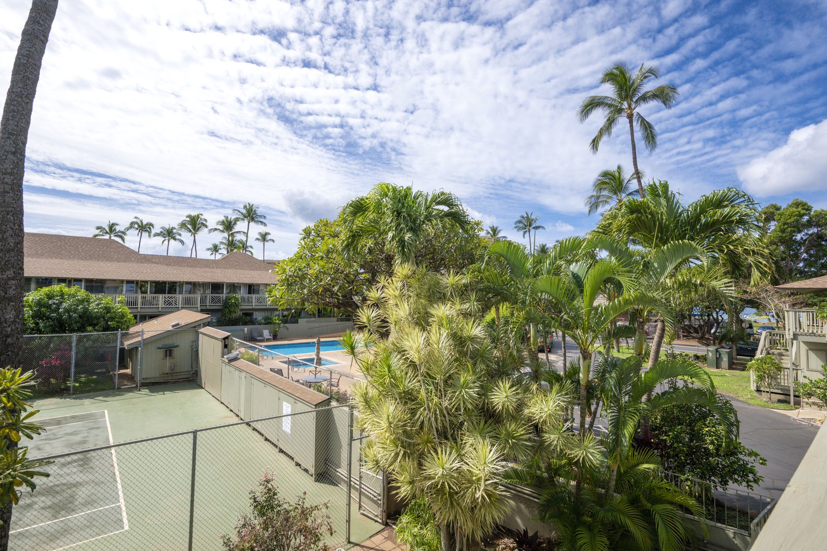 Kihei Vacation Rentals, Kihei Bay Surf B212 - Resort property featuring pool, tennis court and lush tropical landscaping under expansive Hawaiian skies.