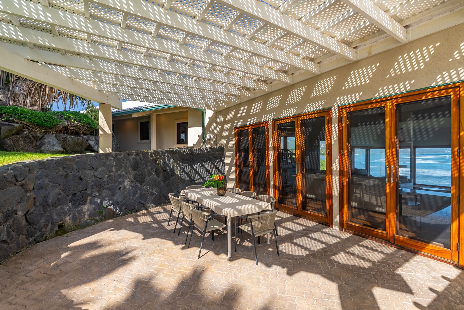 Honolulu Vacation Rentals, Black Point Ocean Villa - Enjoy outdoor dining on your private lanai with dappled sunlight creating beautiful patterns while you savor meals with ocean views.