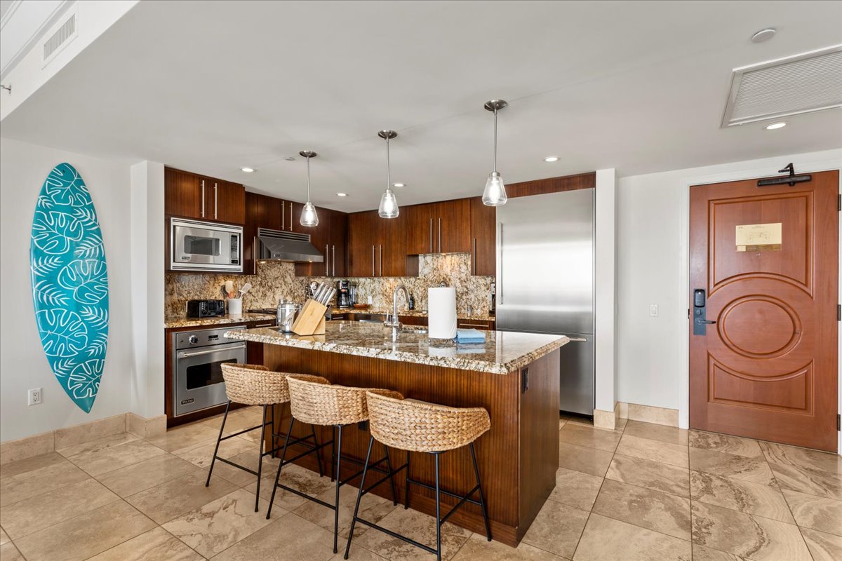 HI Vacation Rentals, Honua Kai Hokulani 825 - Prepare meals in the fully equipped kitchen with a large island and modern appliances.