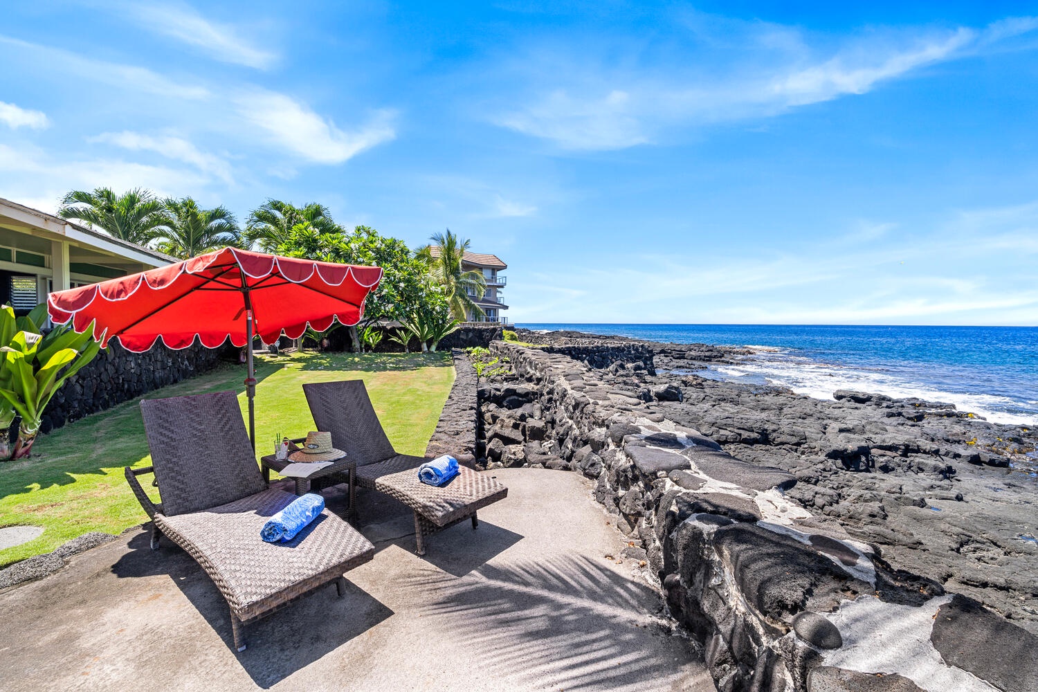 Kailua Kona Vacation Rentals, Honl's Beach Hale (Big Island) - Lounge chairs set on the lava-rock oceanfront, perfect for sunbathing with coastal views.