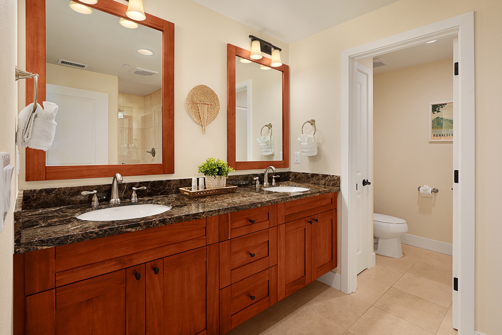 Koloa Vacation Rentals, Pili Mai 6J - Your private bathroom features dual vanities with granite countertops, warm wood cabinetry, and fresh towels waiting for your arrival.