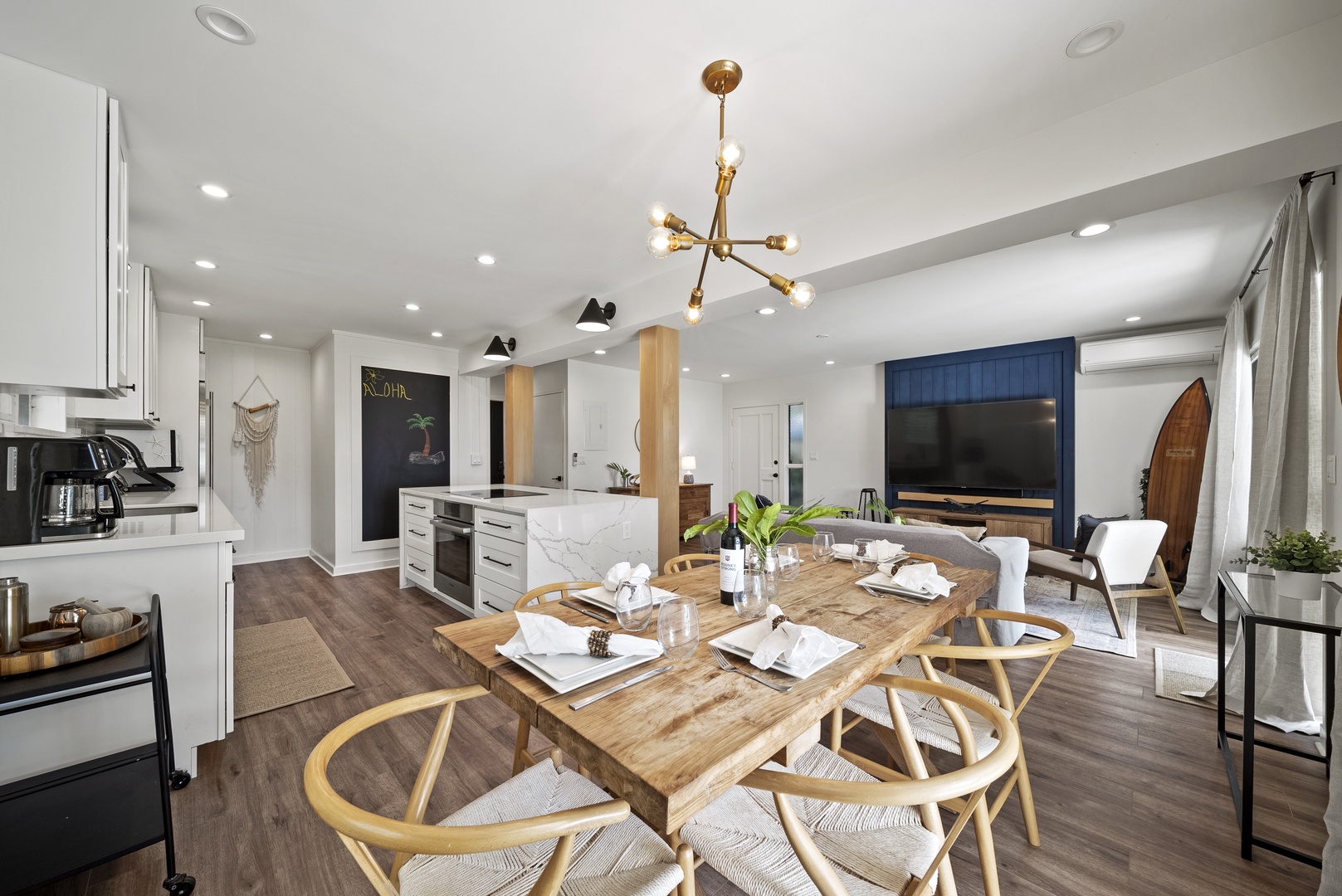 Honolulu Vacation Rentals, Honolulu Beachfront Retreat - Elegant dining area seating six, surrounded by floor-to-ceiling windows showcasing tropical garden views — ideal for unforgettable meals.