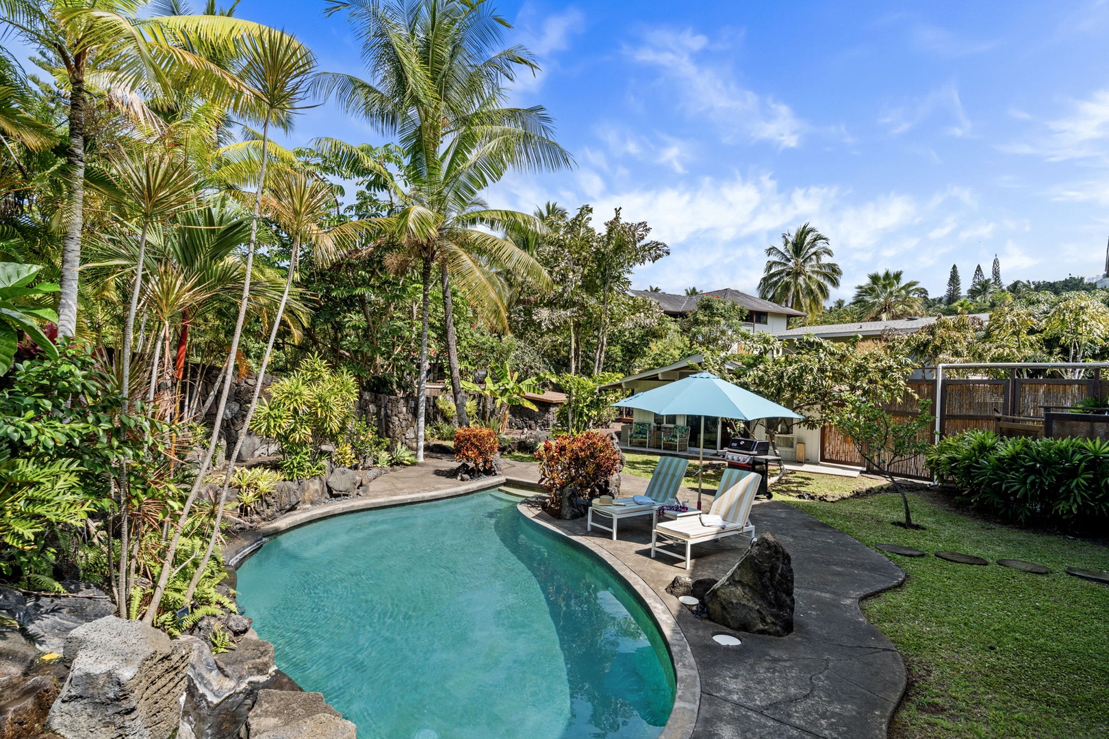 Kailua Kona Vacation Rentals, Mai Tai Manor - Your private tropical oasis awaits with a stunning pool surrounded by swaying palms and lush gardens for pure relaxation.