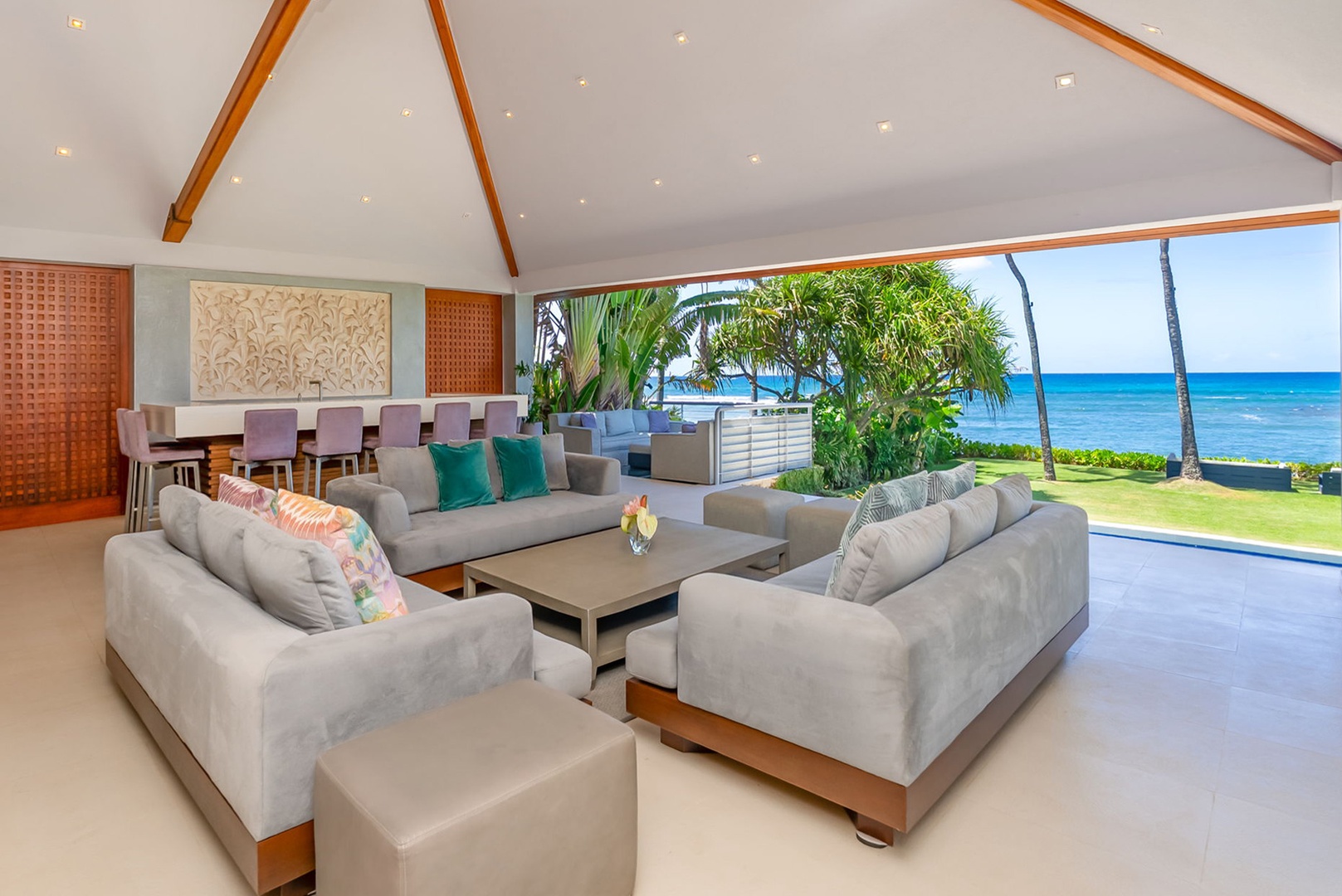 Honolulu Vacation Rentals, Diamond Head Beachfront Estate - Unwind in your spacious living area where modern comfort meets breathtaking oceanfront views, perfect for gathering with loved ones as palm trees sway and the turquoise sea beckons just beyond your open doors.