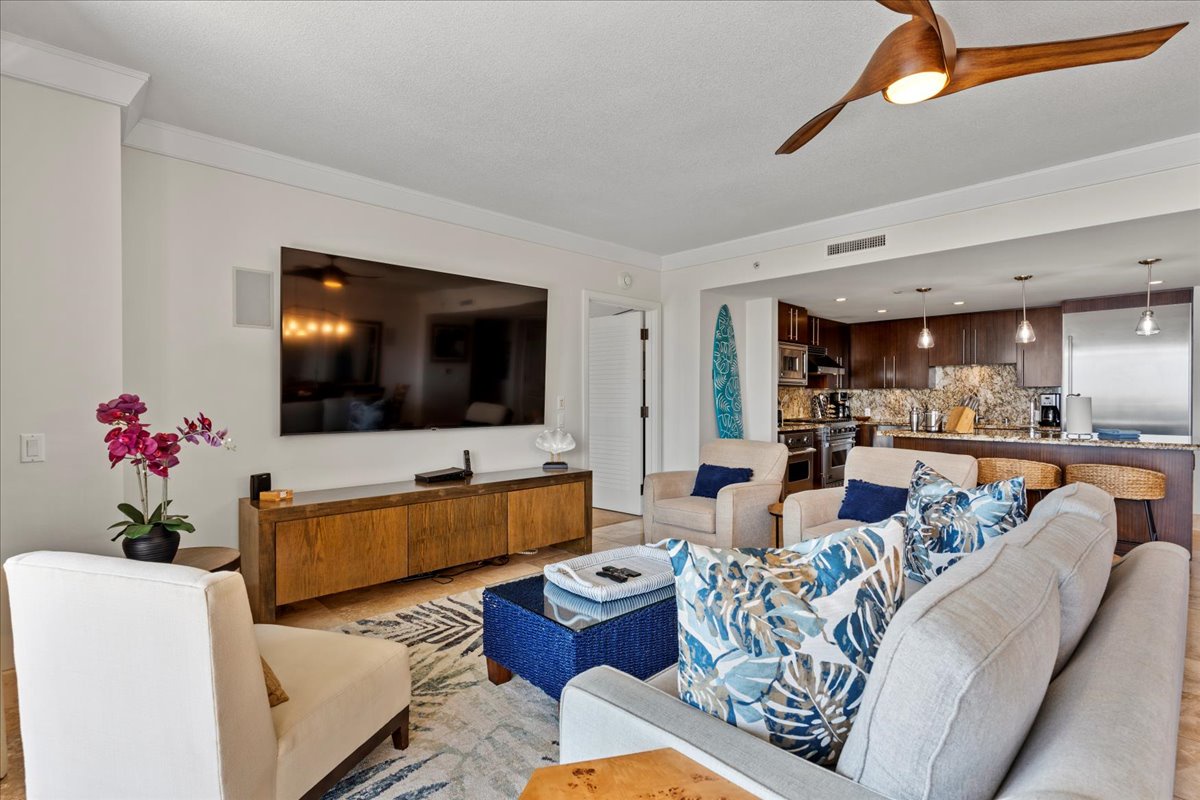 HI Vacation Rentals, Honua Kai Hokulani 825 - Spacious living room with modern entertainment center.