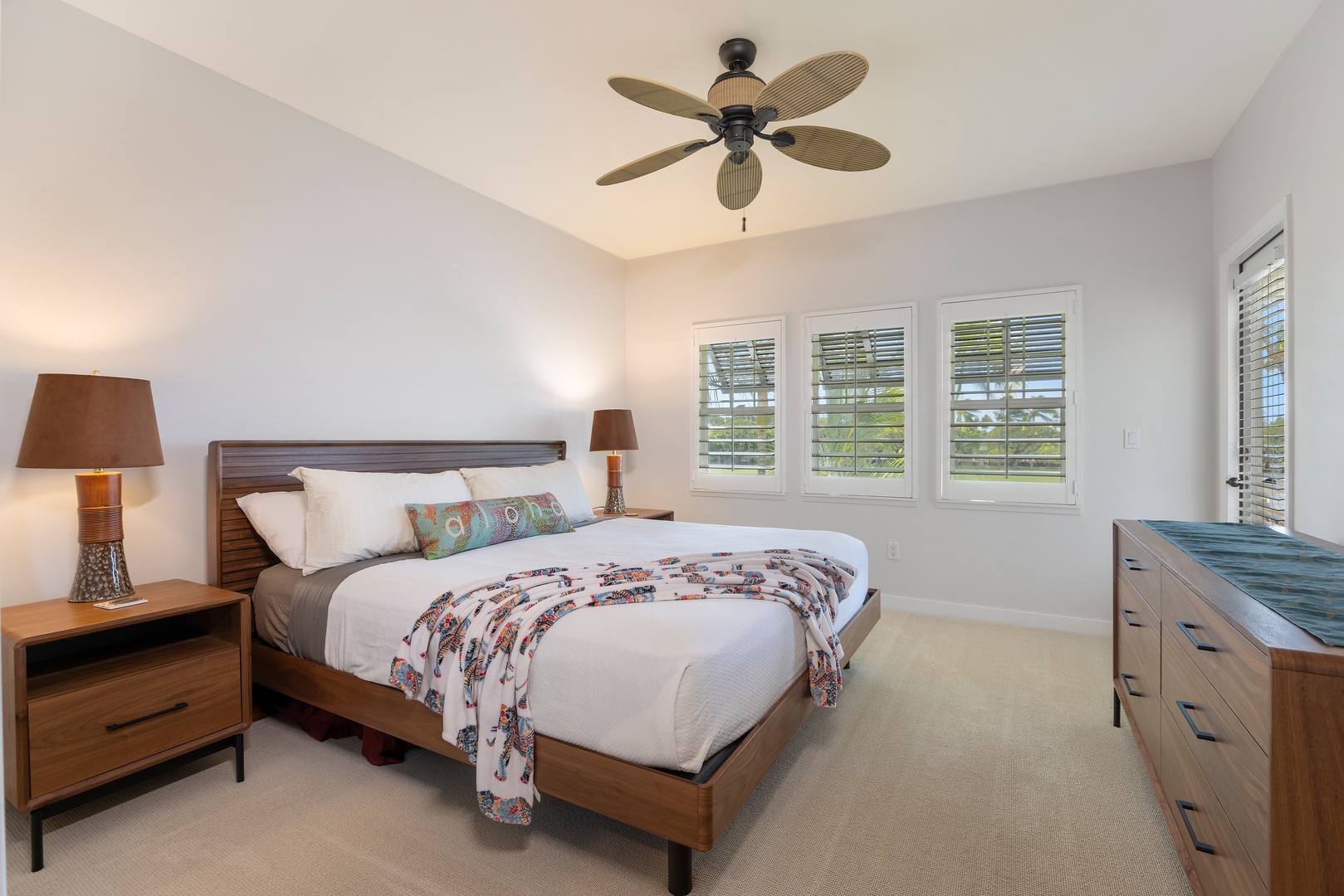 Rest peacefully in your comfortable bedroom with tropical ceiling fan and natural light streaming through plantation shutters.