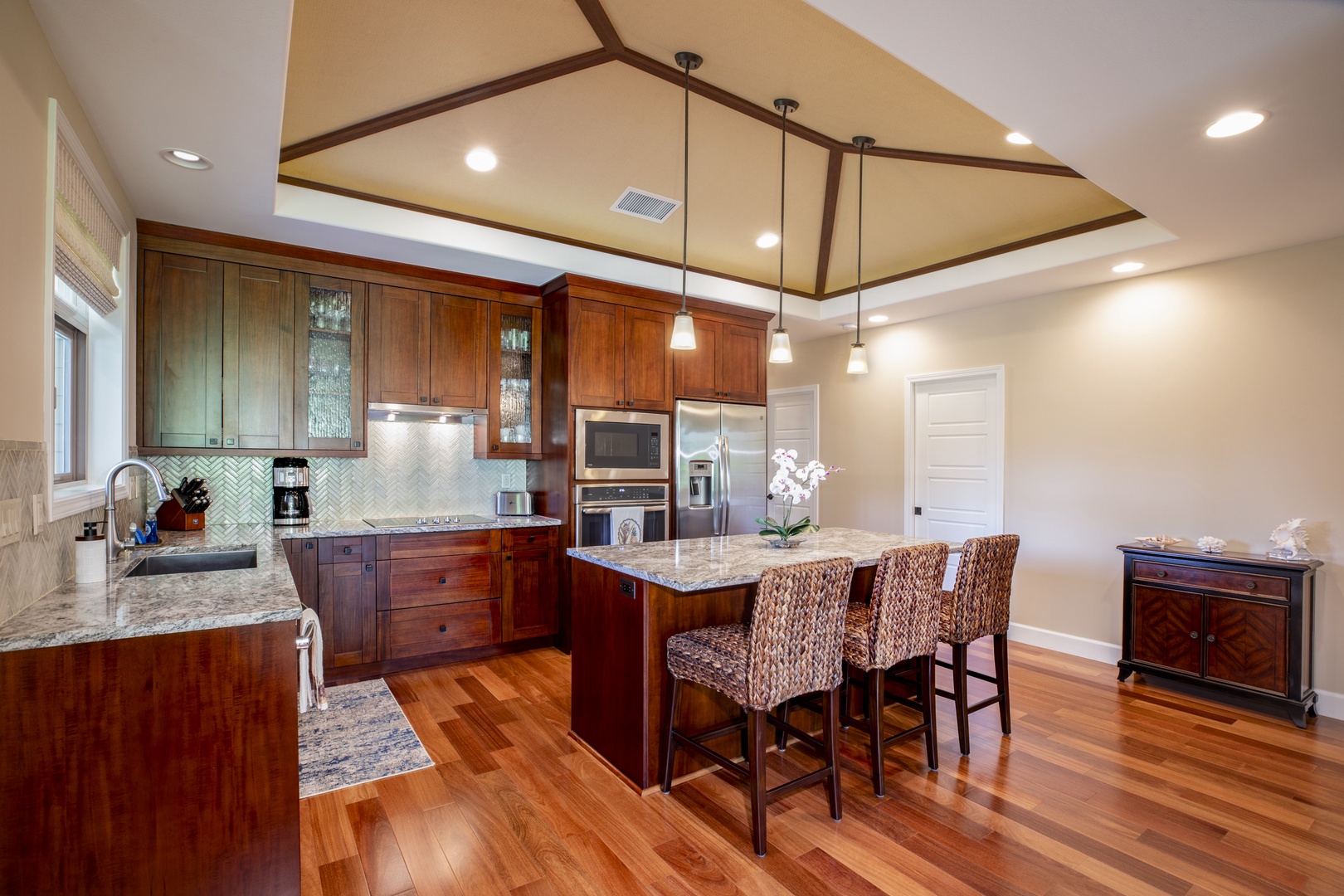 Kamuela Vacation Rentals, Mauna Lani KaMilo #503 - Gather for breakfast or happy hour at the kitchen island, a central hub for food and conversation.