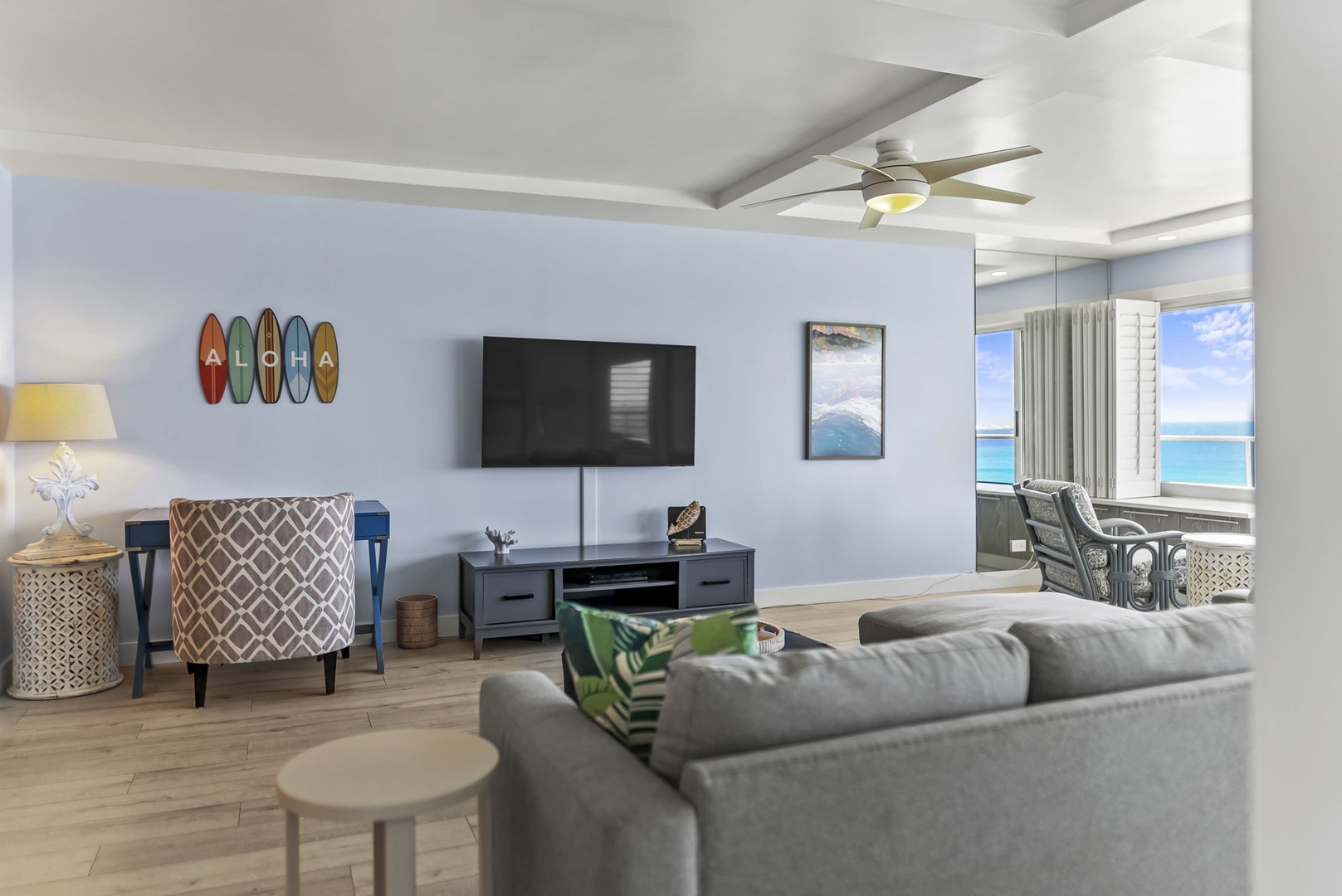 Honolulu Vacation Rentals, Kaimana Tides at Colony Surf - Relax in your bright, coastal-themed living room with stunning ocean views and cozy seating perfect for unwinding after beach adventures.
