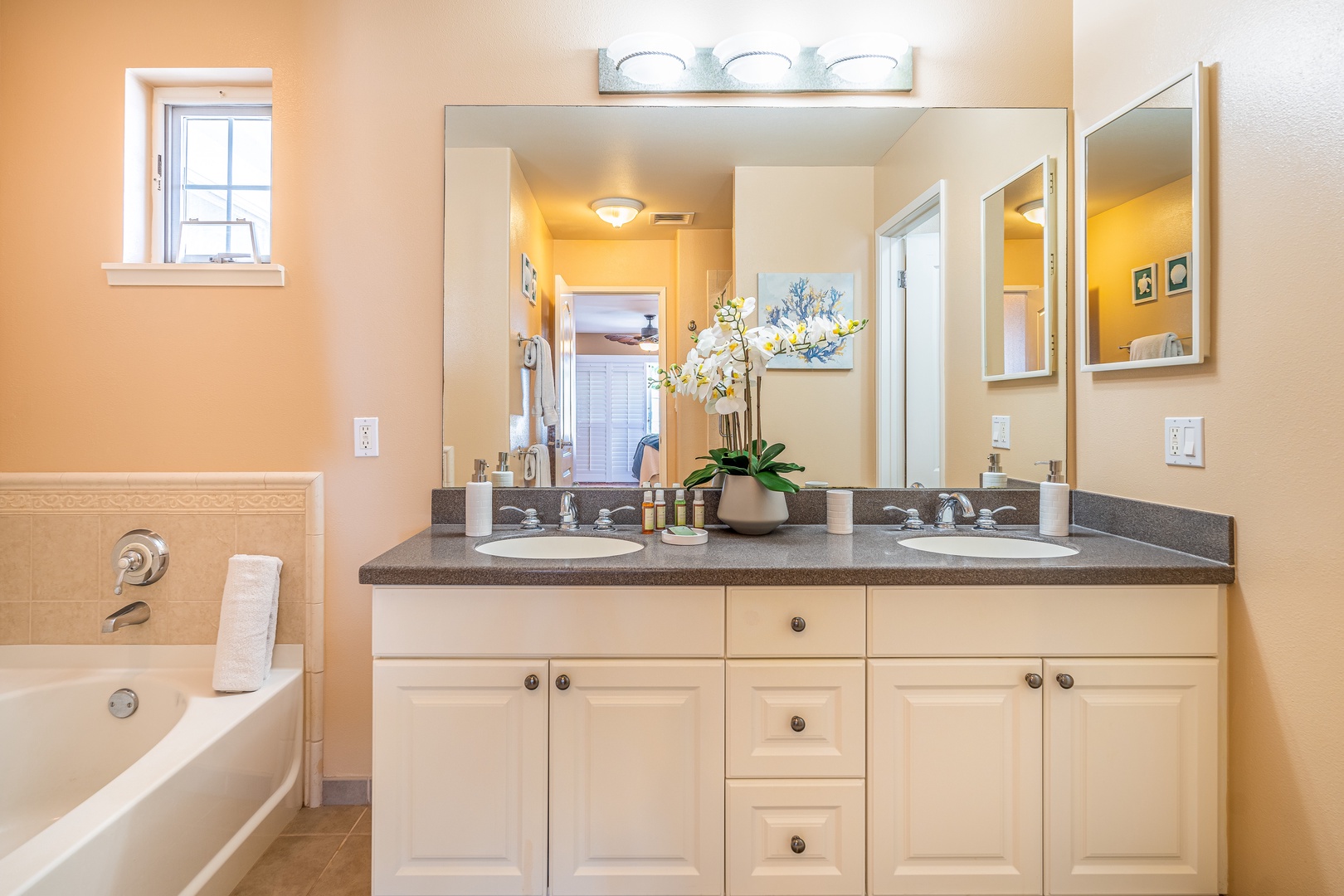 Kapolei Vacation Rentals, Ko Olina Kai 1081C - The primary guest bathroom with a soaking tub and double vanity.