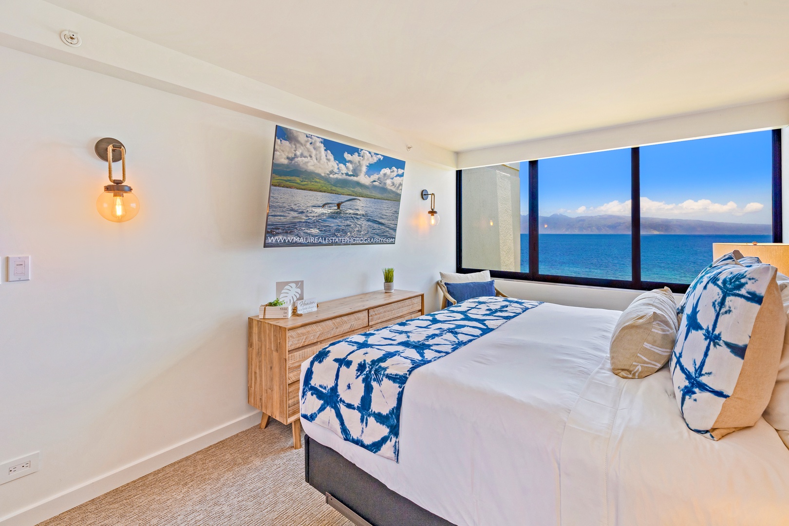 Lahaina Vacation Rentals, Kaanapali Shores 702 - Relax in this cozy bedroom with captivating ocean views and a modern entertainment setup.