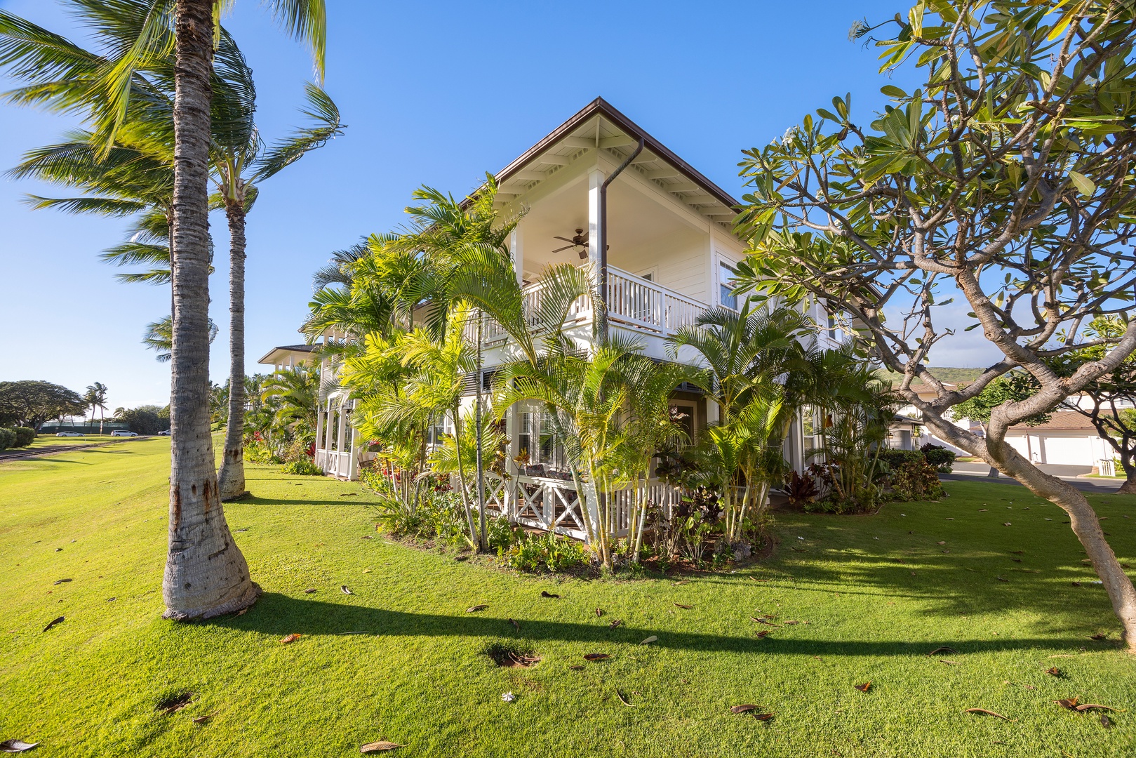 Tropical paradise property nestled among swaying palms and lush greenery on manicured grounds.
