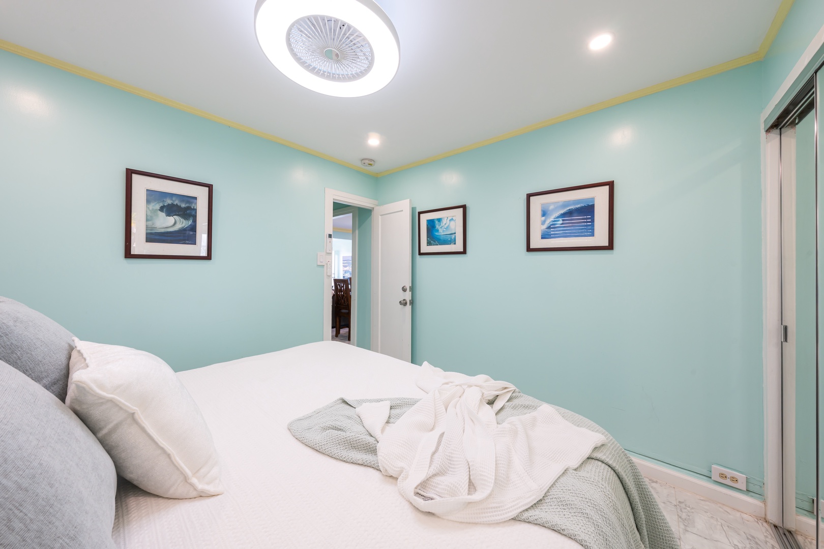 Hauula Vacation Rentals, Private Beach Paradise - A guest room in soft blue, the bed made up in crisp white.