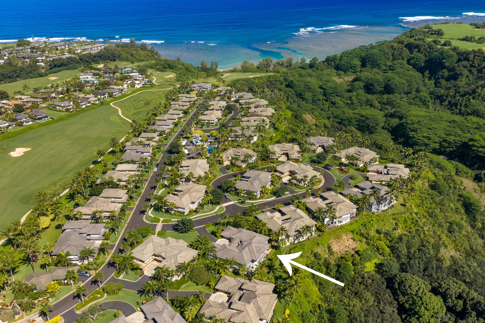 Princeville Vacation Rentals, Kaiulani #8 - Fairway on one side, cliff-top forest on the other, and the arrow marks home.