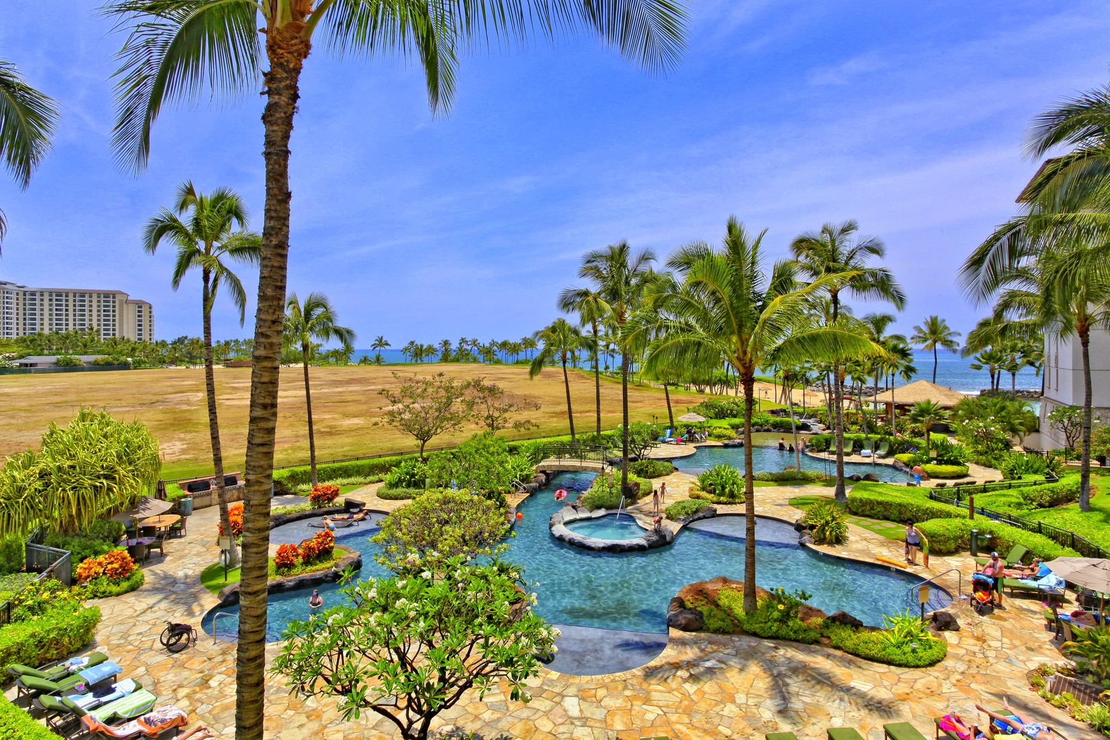 Kapolei Vacation Rentals, Ko Olina Beach Villas B608 - The lagoon pool is an enchanting retreat with swaying palm trees and vibrant island scenery at Beach Villas at Ko Olina.