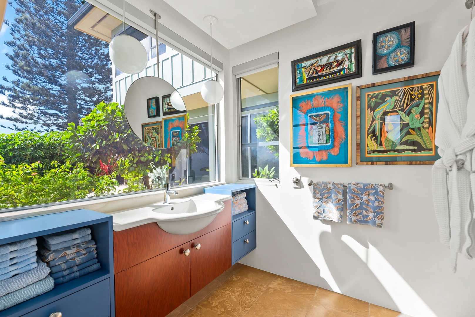 Honolulu Vacation Rentals, Kahala Hills Estate - Art-filled vanity bathroom with plenty of sunlight and bold custom cabinetry.